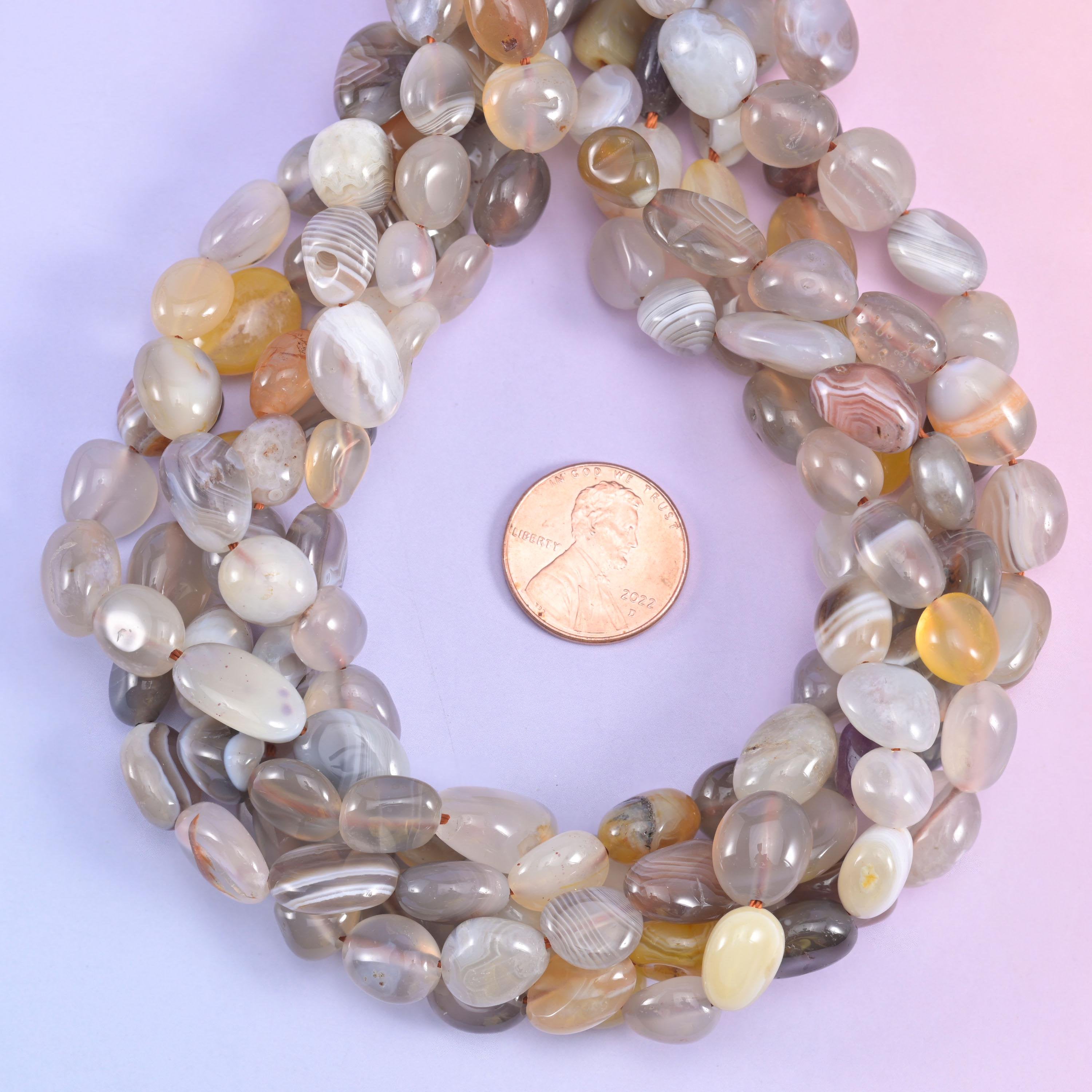 Loop of Botswana Agate pebble beads encircling a penny for scale