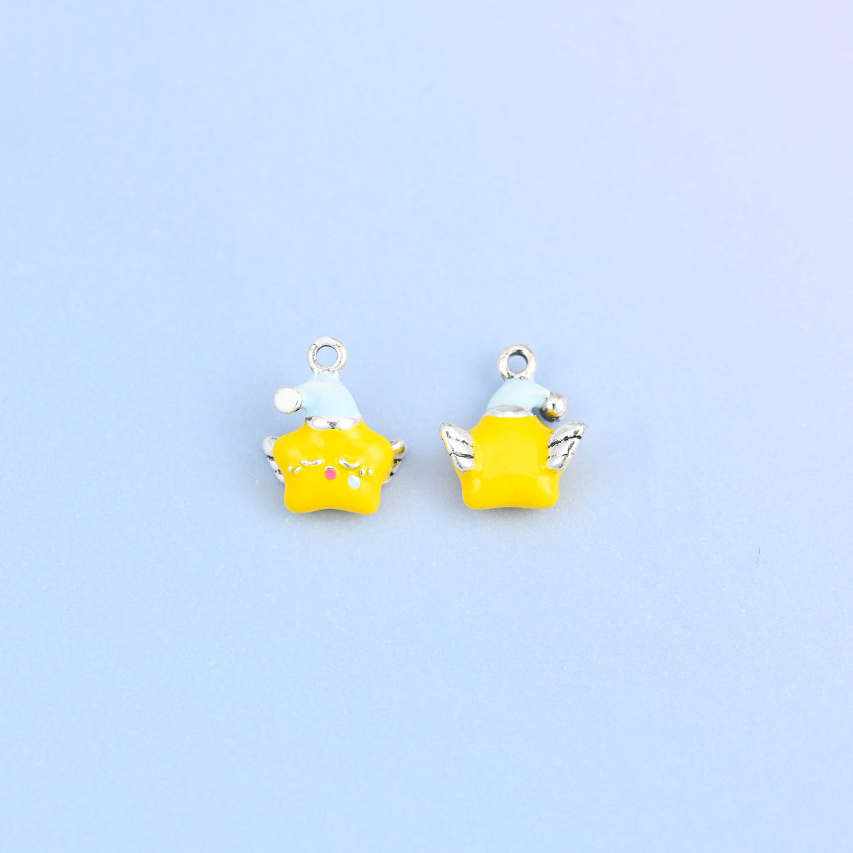 Two star charms in light blue hats, front and back, yellow enamel star with silver-tone wings.
