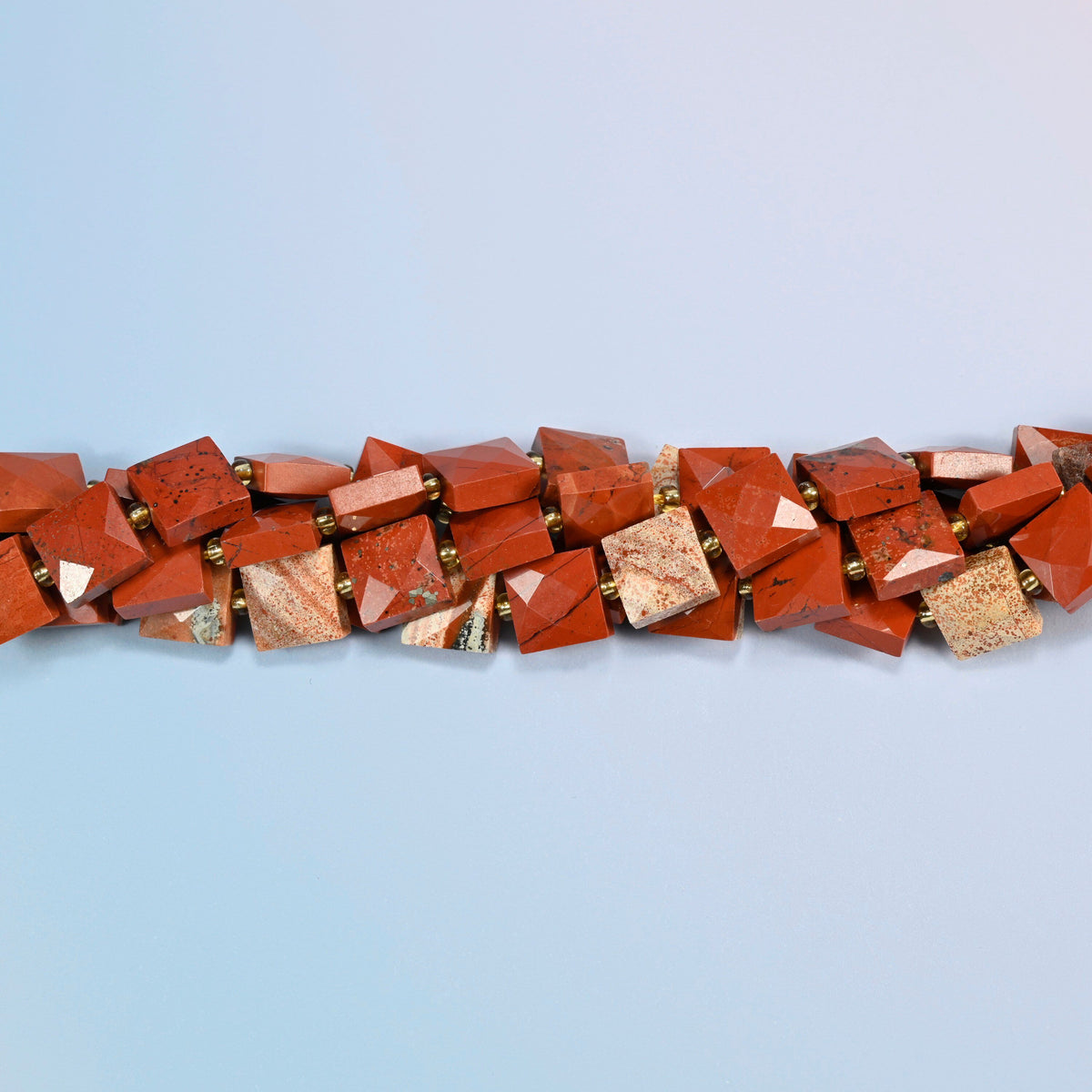 Strands of natural flower red jasper faceted flat square beads twisted together in a horizontal row