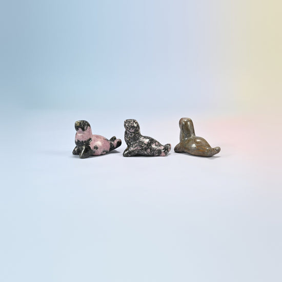 Three rhodonite sea lion crystal carvings, 1.5 inch, pink and black natural stone