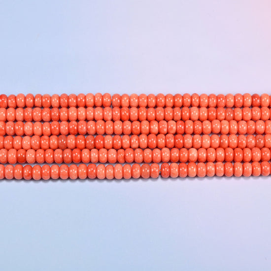 Red Orange dyed jade gemstone rondelle beads in straight rows, showing the flat 5x8mm disc profile and centre drilling