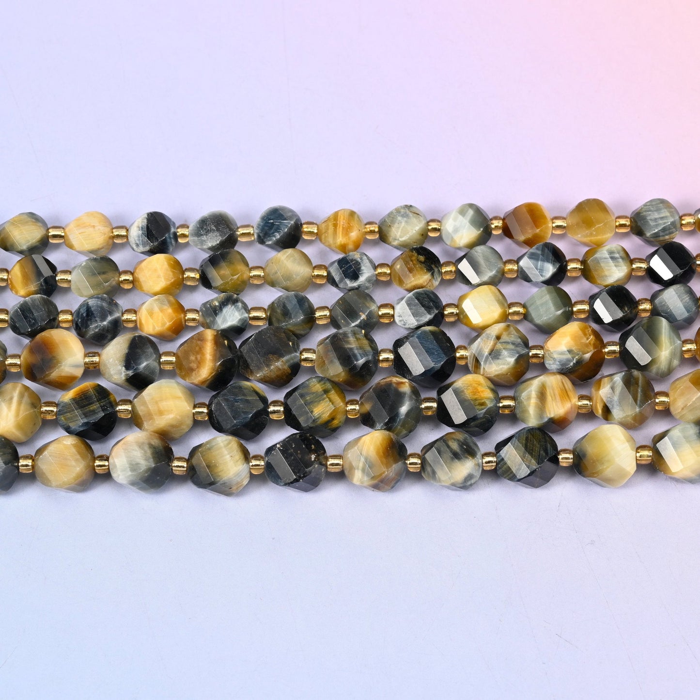 Dream Tiger Eye beads banding honey gold against steely blue-grey and near-black