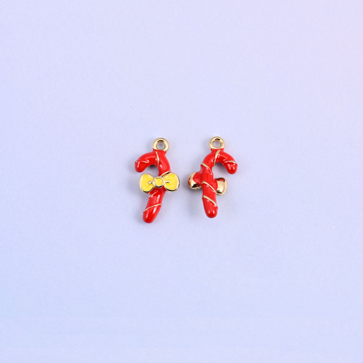 Two candy cane charms, one turned to show the plain gold-tone back of the cane.