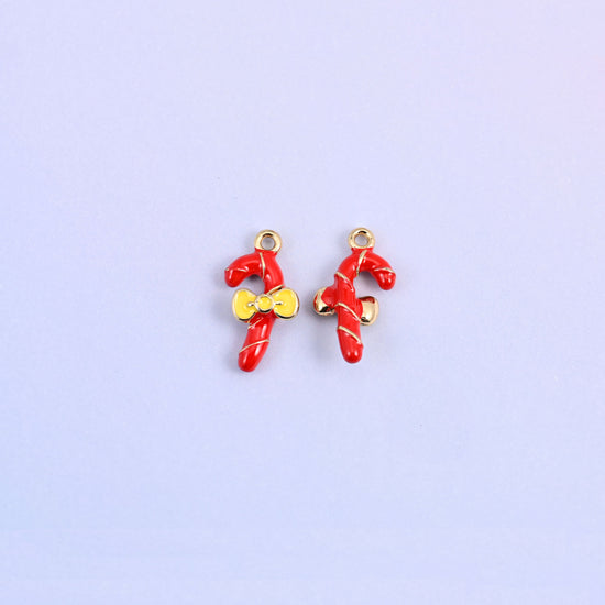 Two candy cane charms, one turned to show the plain gold-tone back of the cane.
