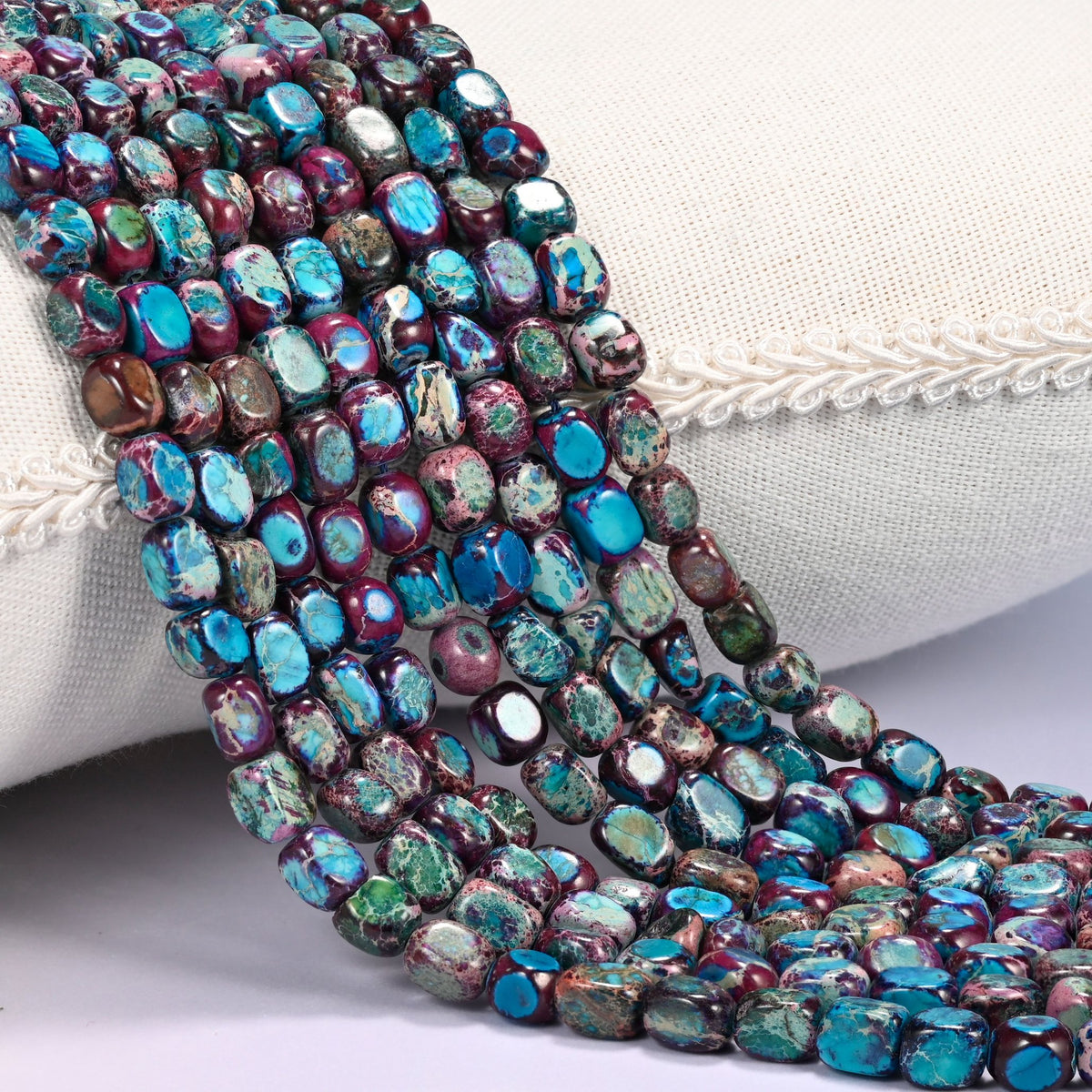 Purple Dyed Sea Sediment Jasper Nugget Beads in deep plum and wine purple with bright turquoise patches.
