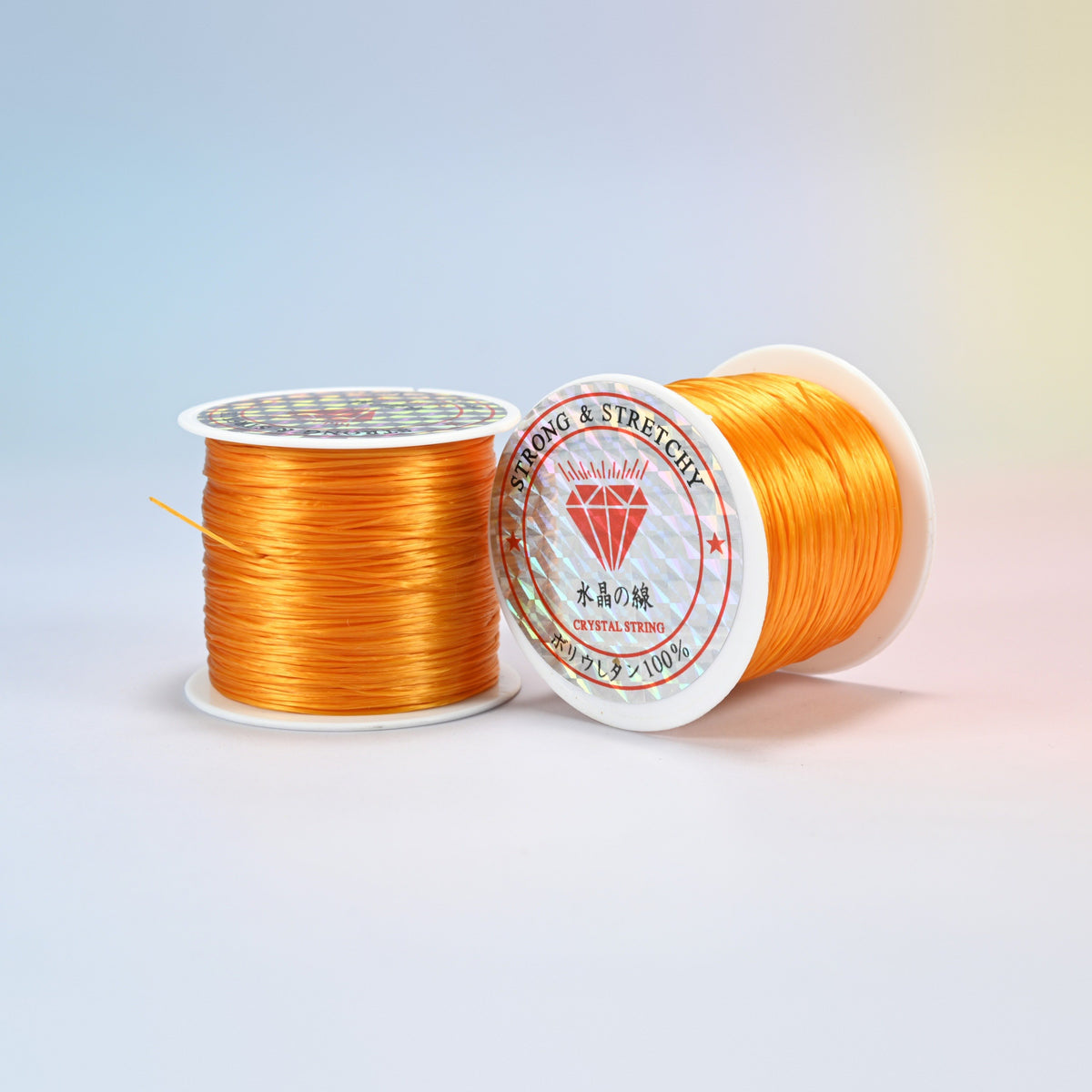 Two rolls of light orange 0.7-0.8mm elastic stretch string, glossy polyurethane bead cord with a holographic label