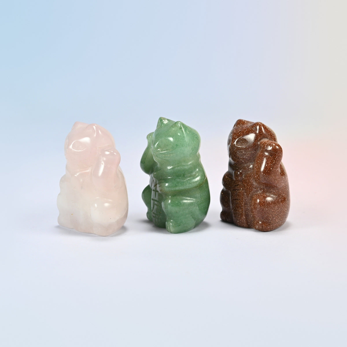 Rose quartz, green aventurine and gold sandstone lucky cats side by side with raised paws