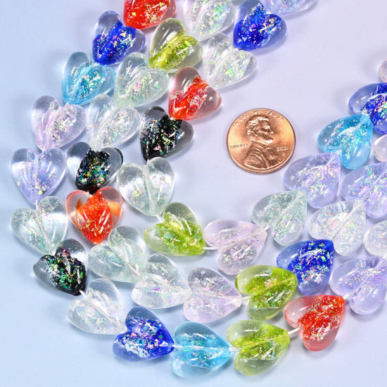 Puffed heart-shaped glass beads with iridescent rainbow coating