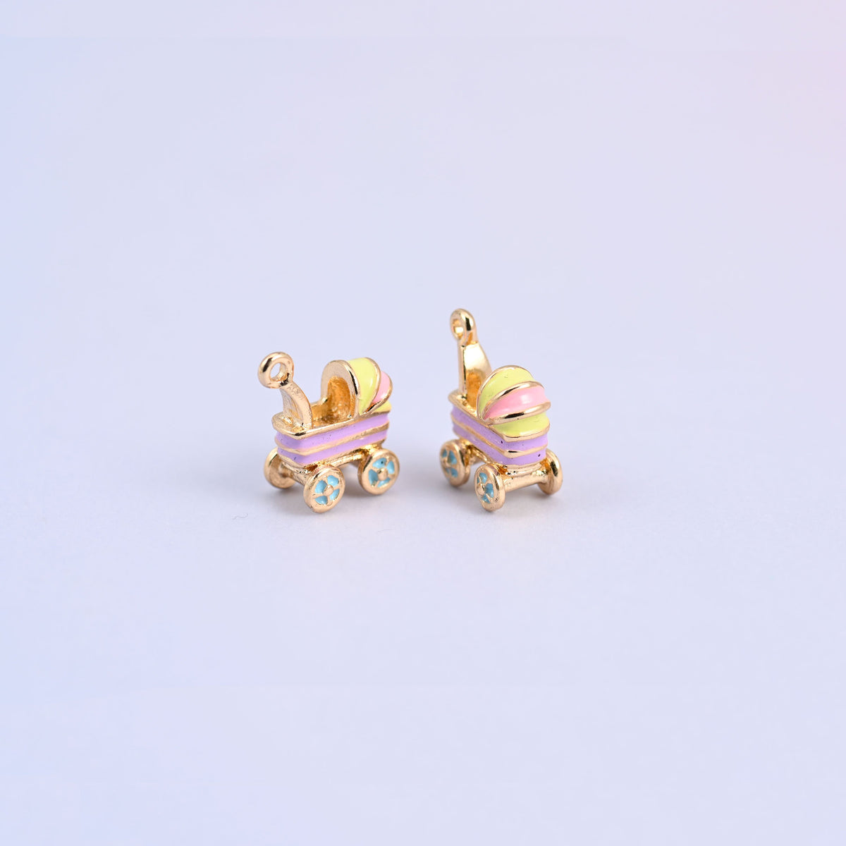 Two light purple stroller charms angled to show the 7.15mm thick three dimensional carriage.
