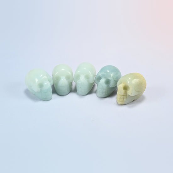 1 inch skull crystal carving in amazonite, soft green natural stone with white streaks