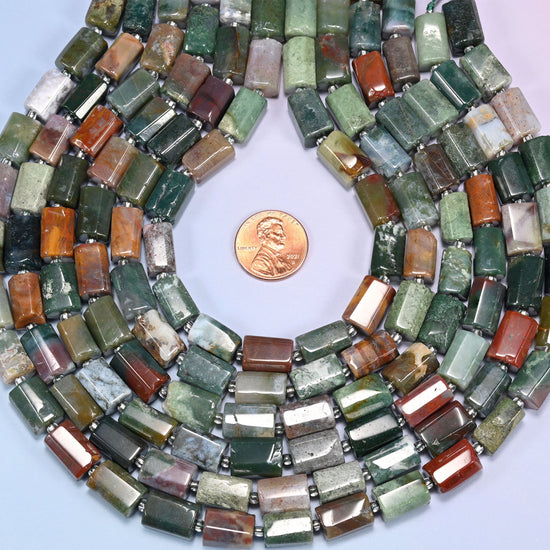 Top-down view of faceted Indian Agate tube bead strands arranged in a loose spiral on a lavender background.