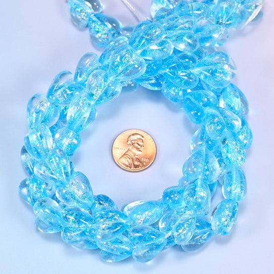 Iridescent light blue heart glass beads measured at 16x15mm, glass hearts for charm bracelets and earrings