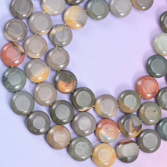 Overhead loop of picture jasper coins showing the range from plain grey to heavily banded