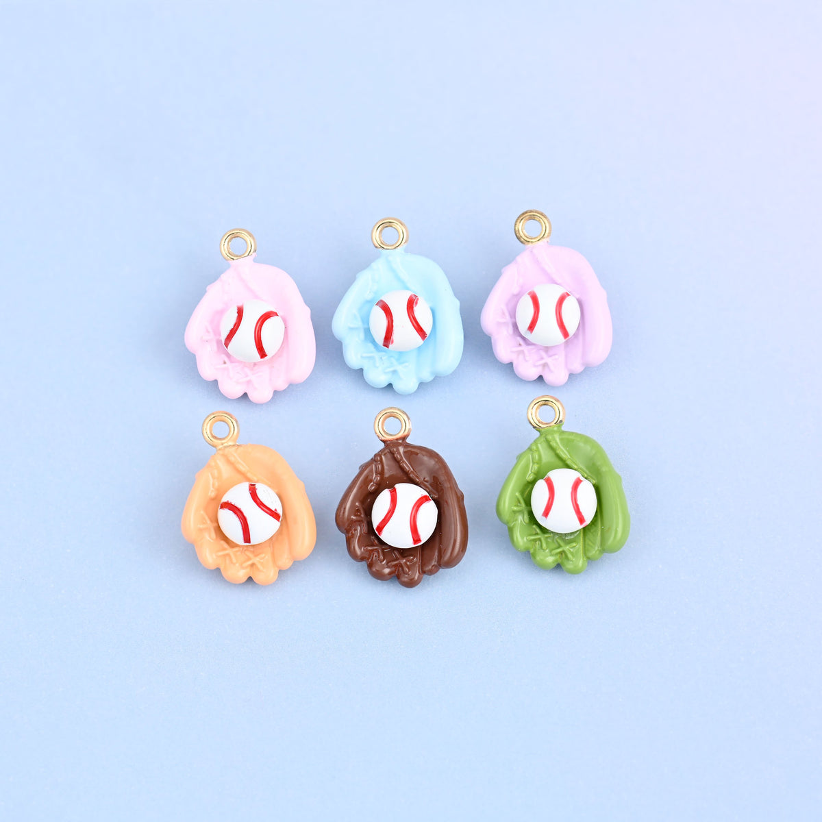 Six baseball charms arranged in two rows, one in each glove color with a white ball in every pocket.