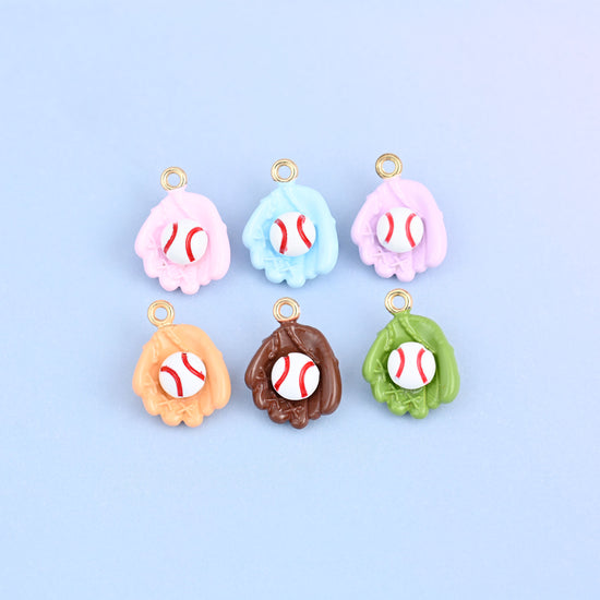 Six baseball charms arranged in two rows, one in each glove color with a white ball in every pocket.