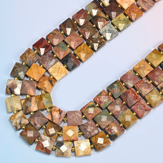 Natural red howlite faceted flat square beads in several strands curved into a wide U, brick red, olive green and tan stone