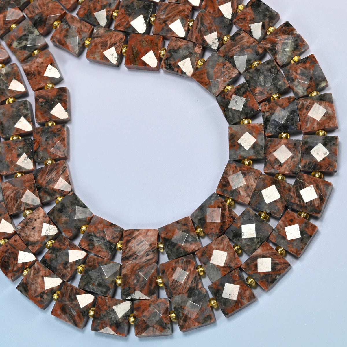 Natural red sesame jasper faceted flat square beads curved into an open loop, brick red and red-brown beads with dark speckles