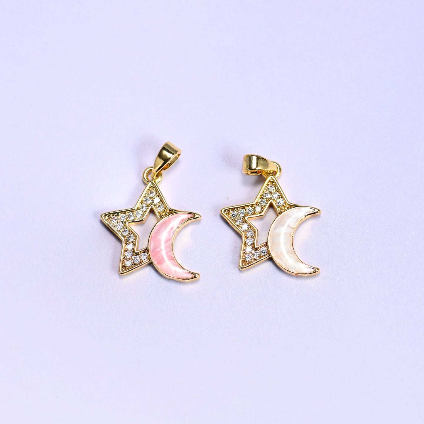Both colorways of the Star Shell Moon Zirconia Charms together, pink shell crescent on the left and white shell crescent on the right.
