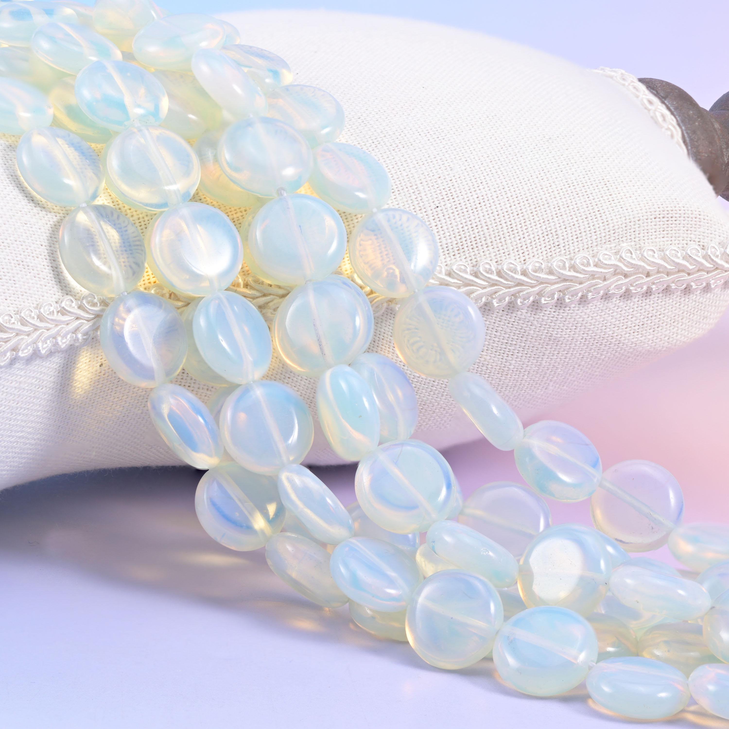 Opalite smooth coin beads, a milky semi-translucent man-made glass with a blue-white glow