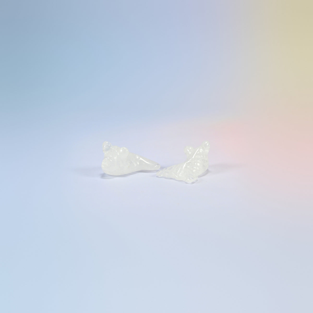 Two 1.5 inch natural clear quartz goldfish carvings, white and icy clear