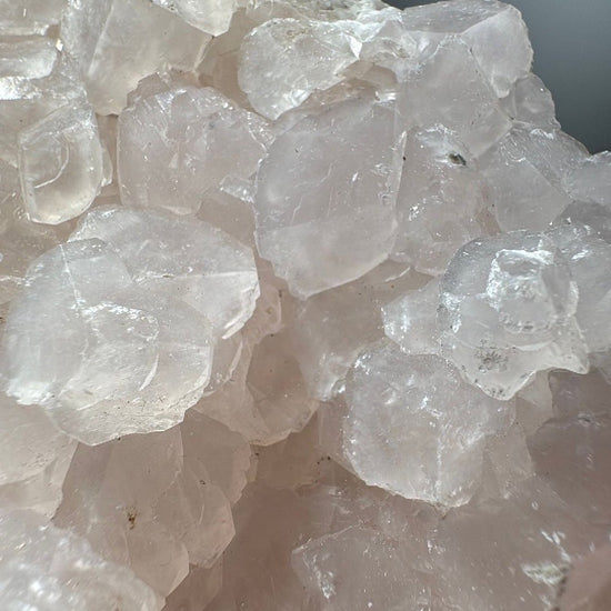Close detail of semi-translucent calcite crystals with stepped rhombic faces