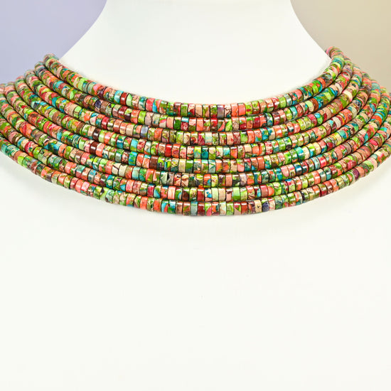 Dyed blue green sea sediment jasper heishi disc strands arranged as a layered collar on a white display bust