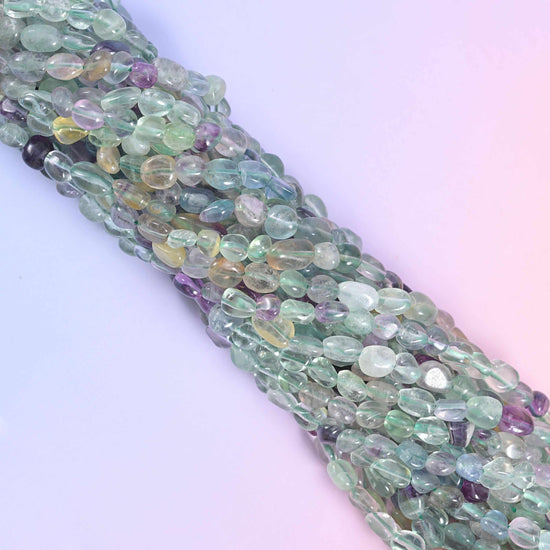 Fluorite strands running diagonally across a pale blue and lilac background