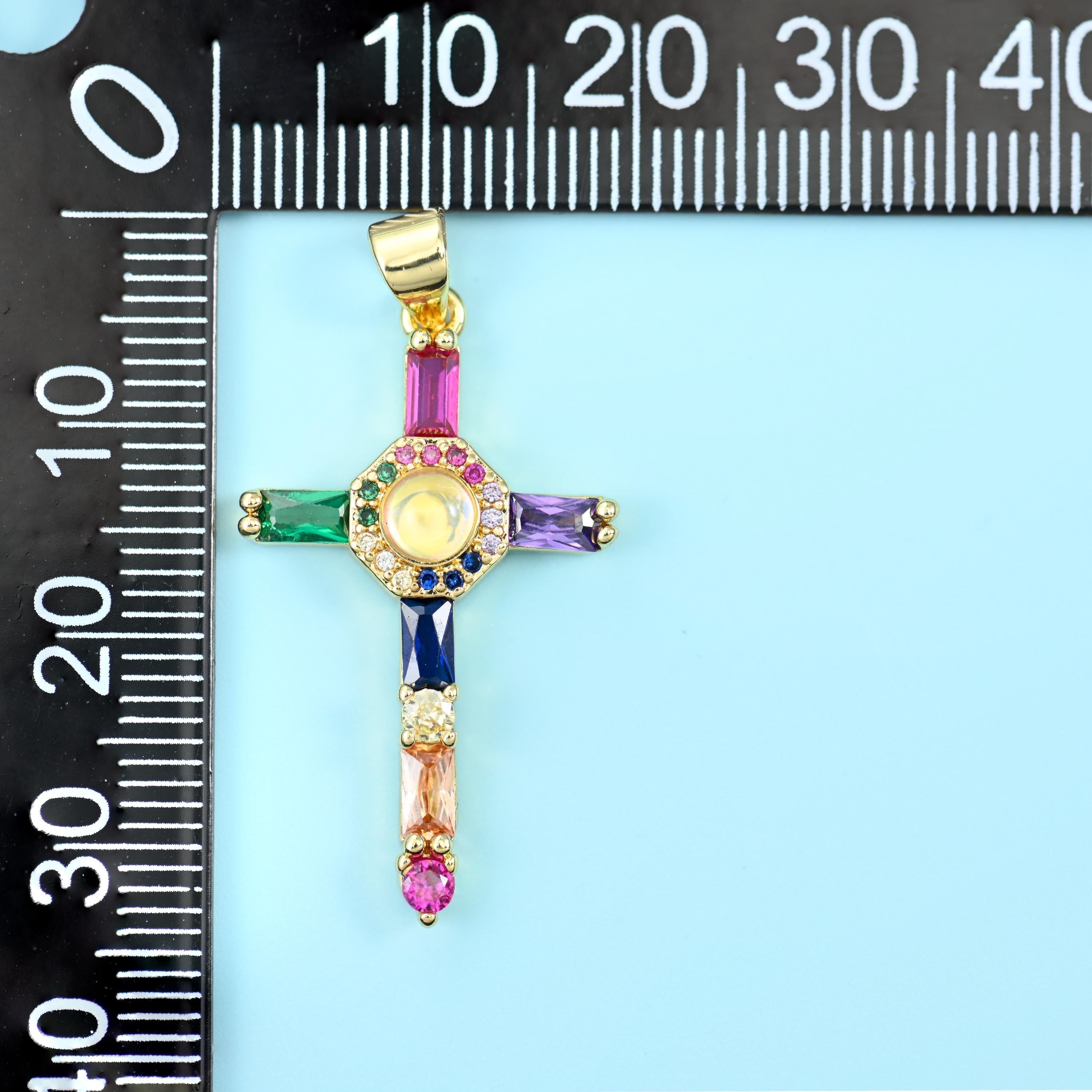 18K gold plated cross zirconia pendant on a black millimetre ruler, measuring about 35mm including the bail.