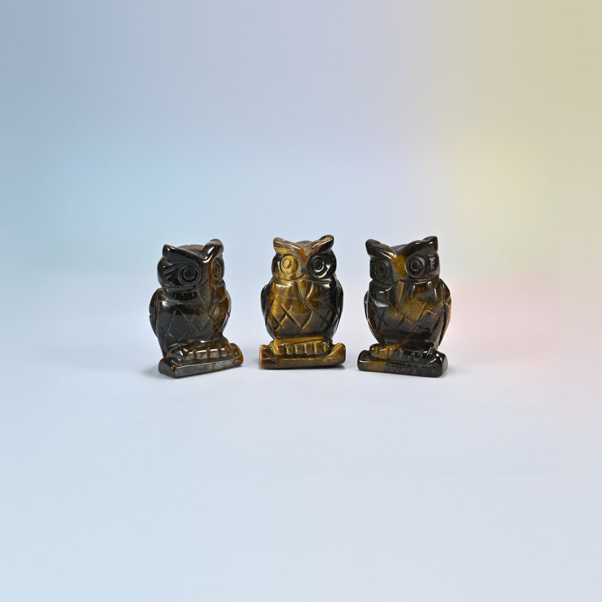 Owl crystal carving in tiger eye, golden brown natural stone with shimmering bands