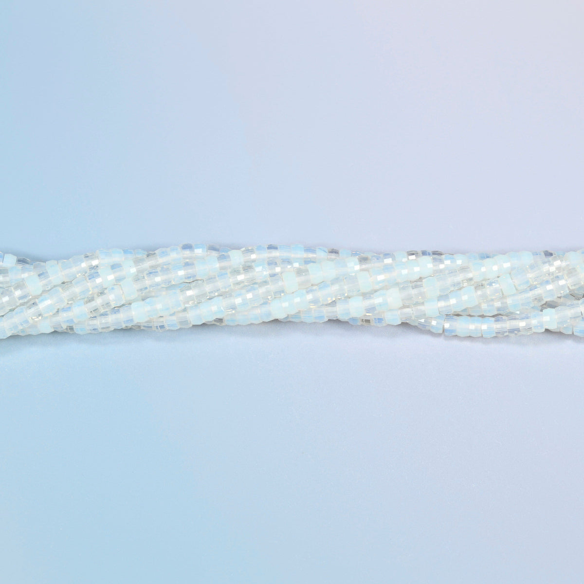 Strands of opalite faceted heishi disc beads twisted together in a horizontal row