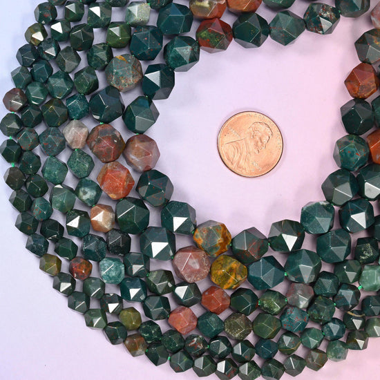 Indian Bloodstone diamond star cut beads coiled around a US penny for size reference, centre drilled