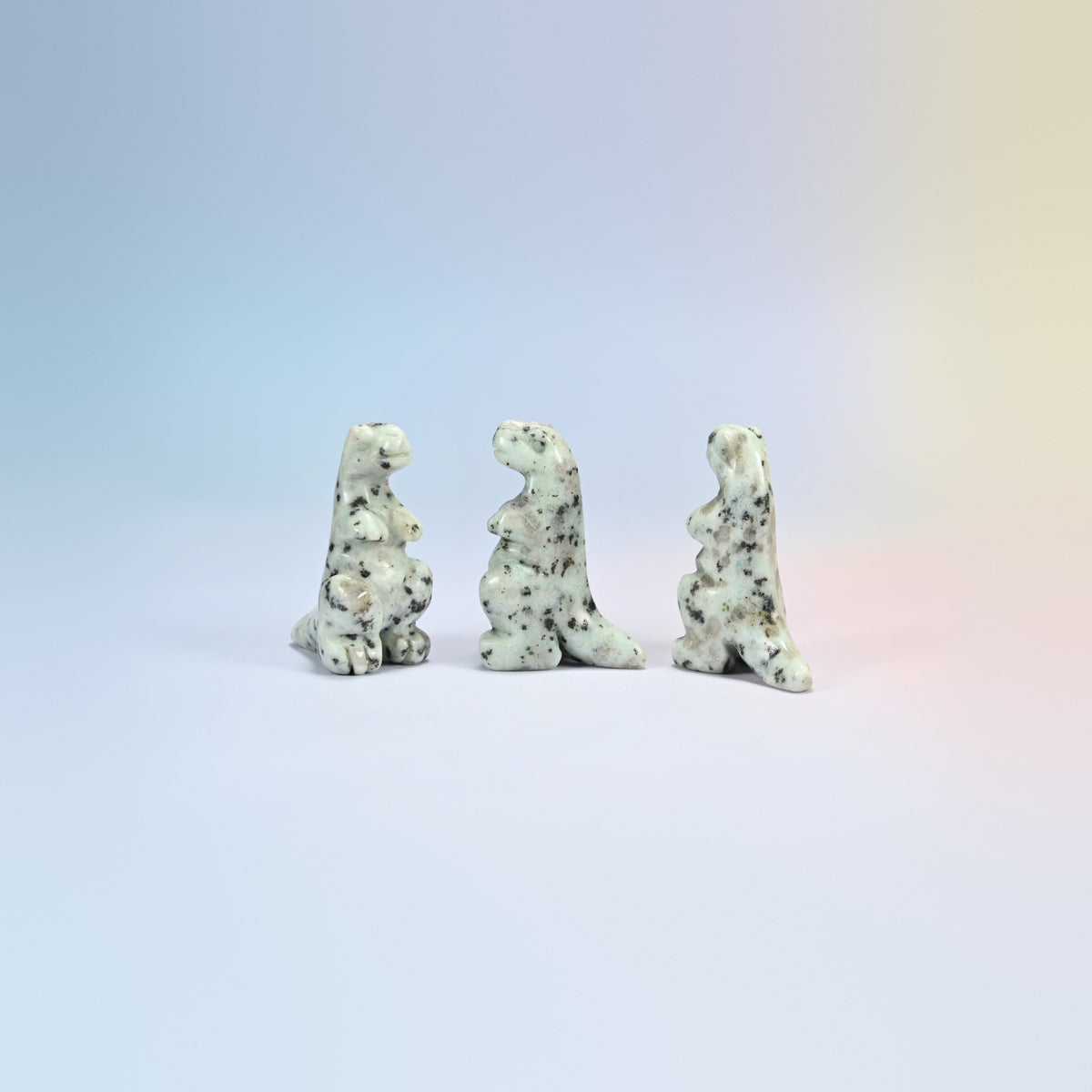 Three kiwi jasper T-Rex dinosaur crystal carvings, 2 inch, cream natural stone with dark spots