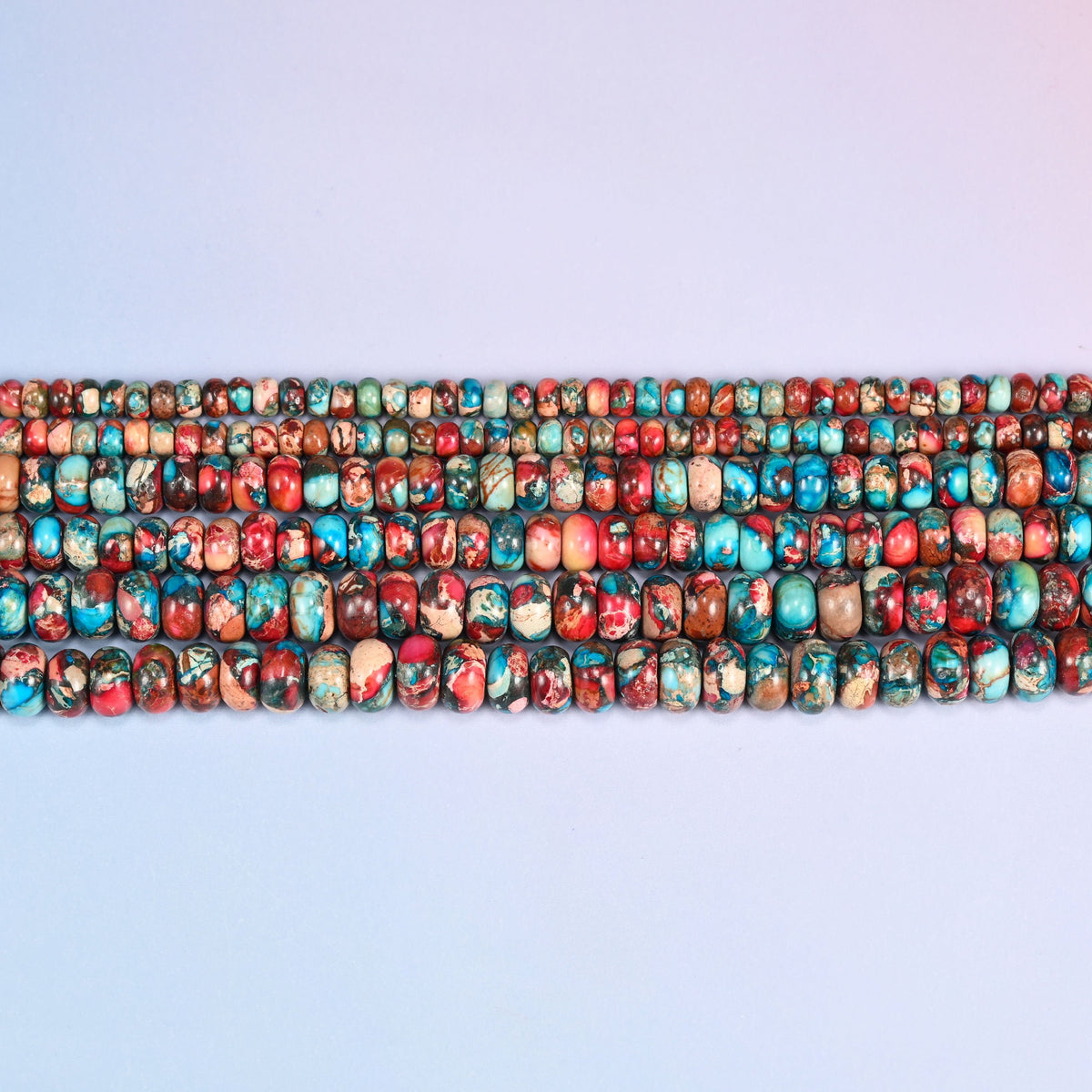 Red Dyed Sea Sediment Jasper rondelles in brick red and burnt orange with turquoise veining.