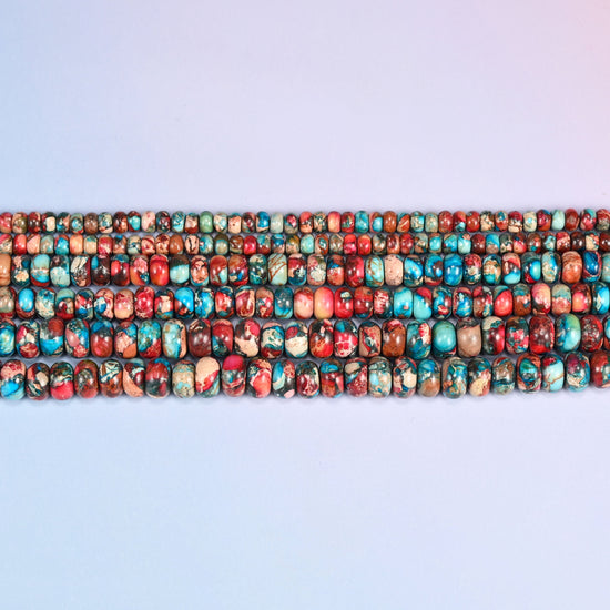 Red Dyed Sea Sediment Jasper rondelles in brick red and burnt orange with turquoise veining.