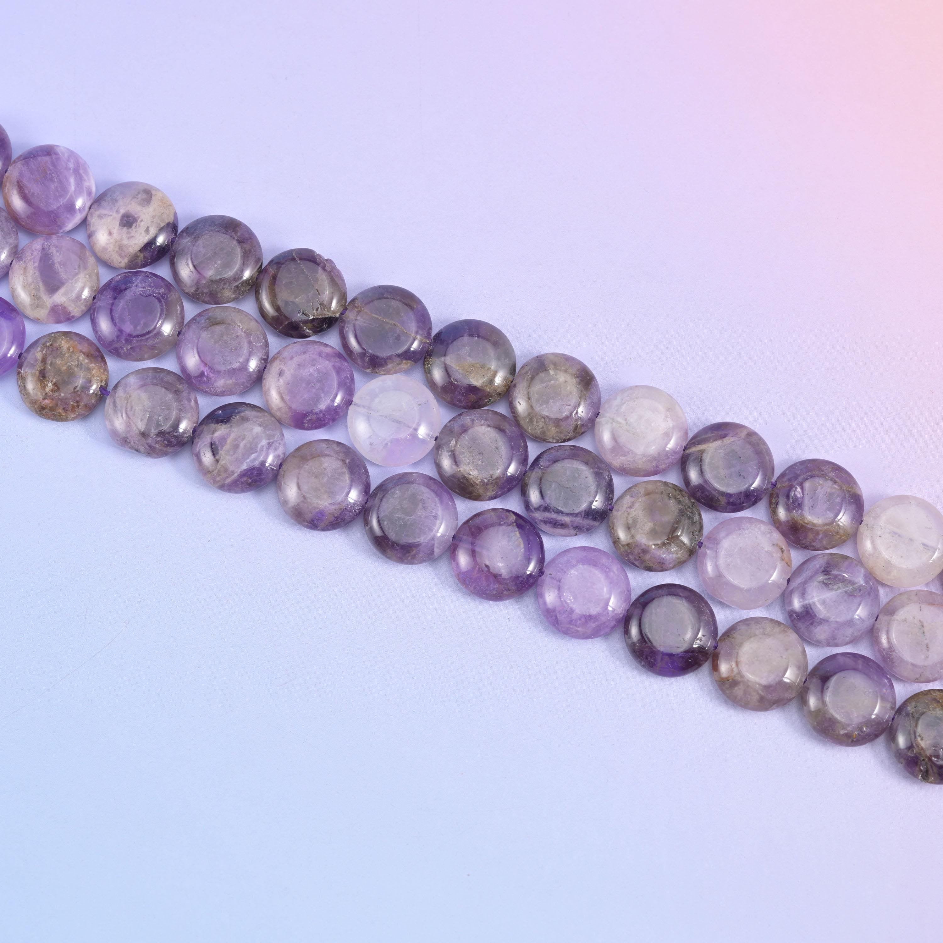 Diagonal run of 15mm Amethyst coins across a soft blue background