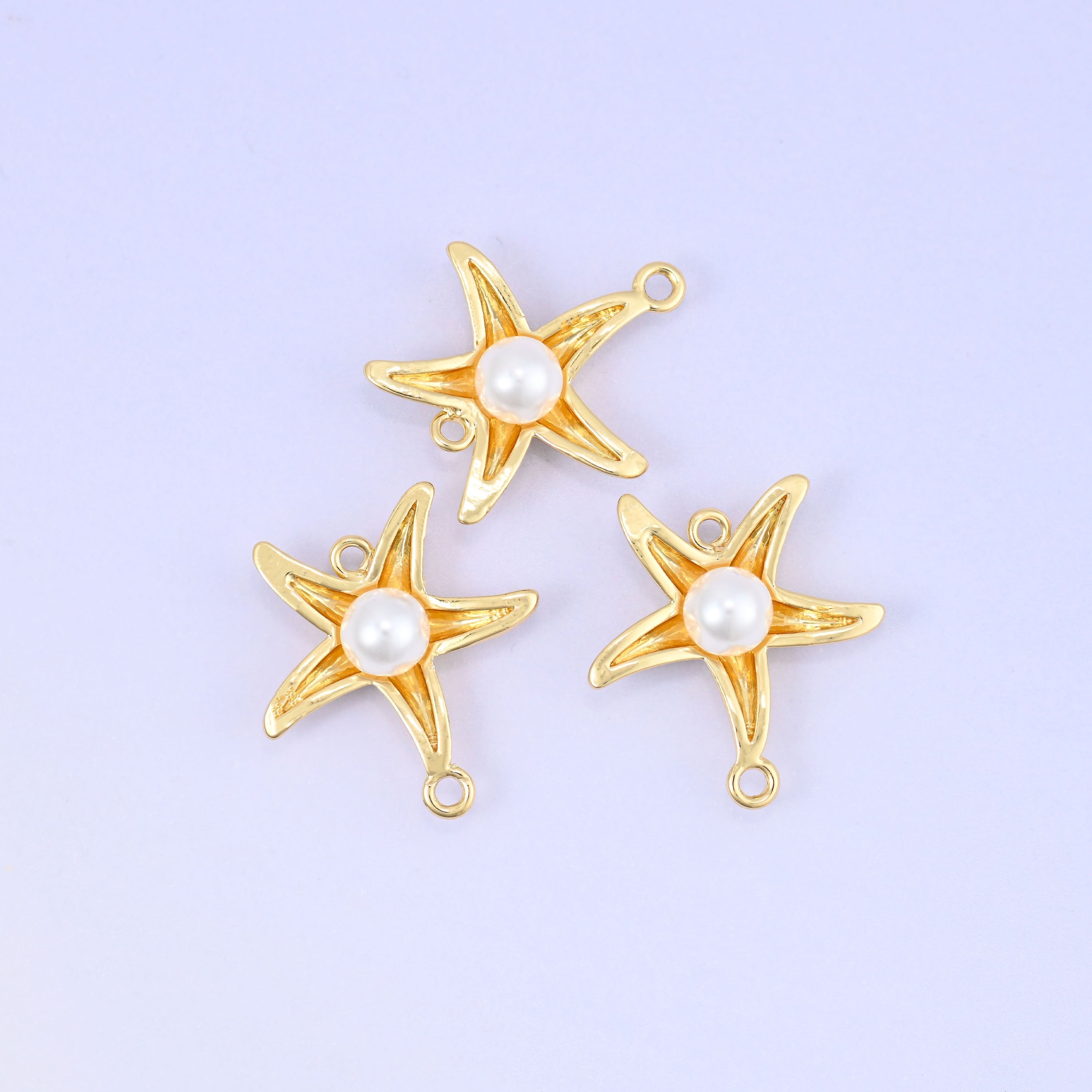 Polished gold plated sea star charm with white pearl accent and double connector loops