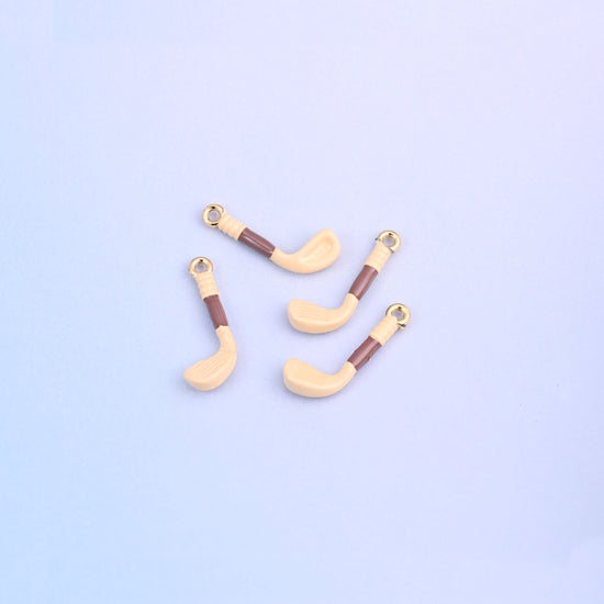 Four light orange golf club charms with brown enamel grips.