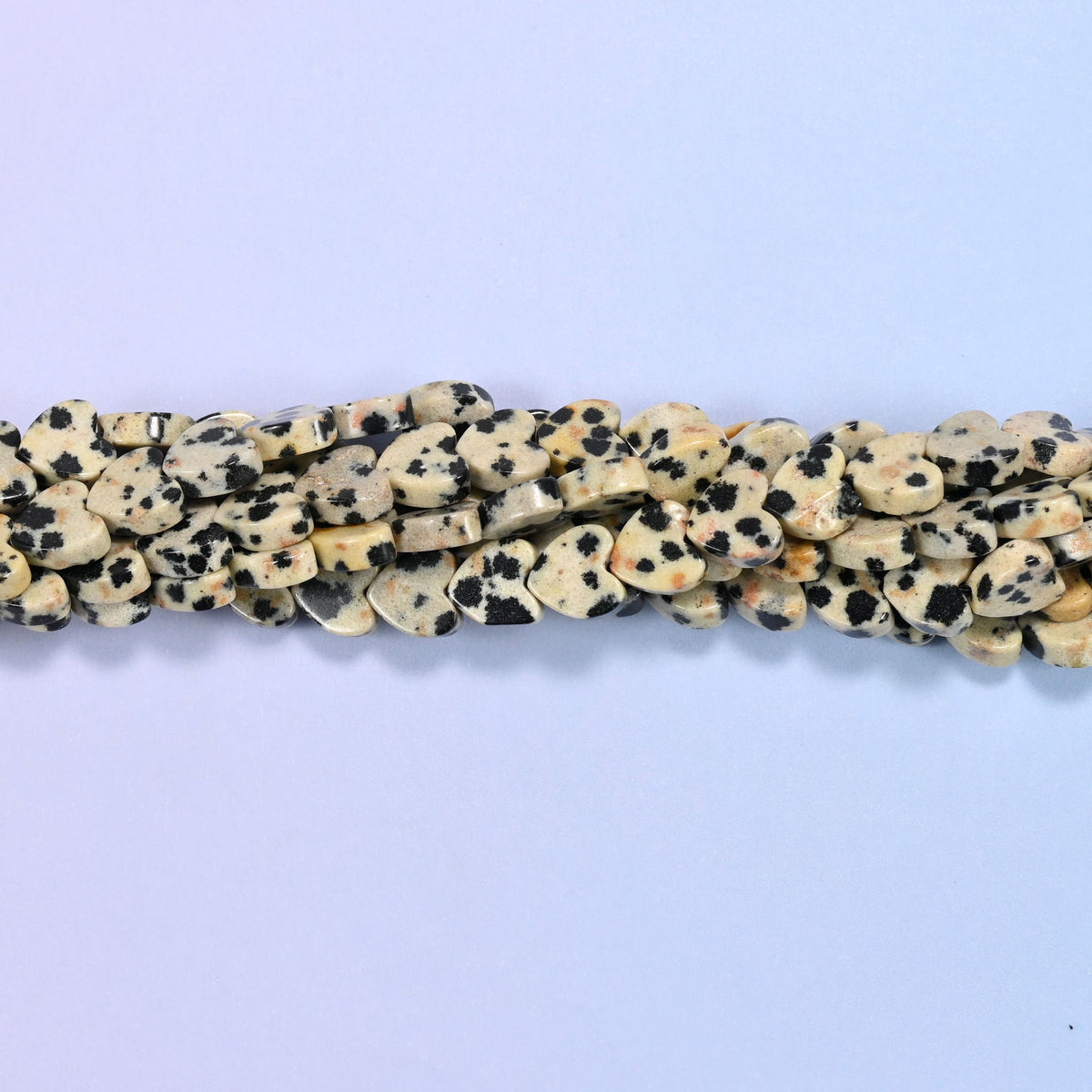Dalmatian Jasper Flat Heart Beads, cream and bone-coloured stone freckled with inky black spots