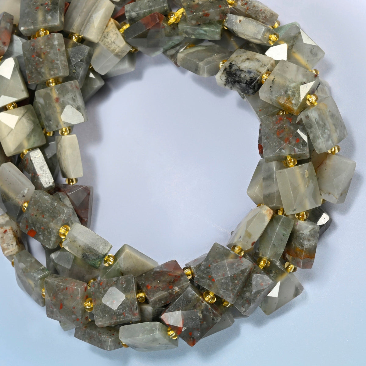 Natural African bloodstone faceted flat square beads coiled into overlapping loops, whole strands of gray-green stone spotted with red