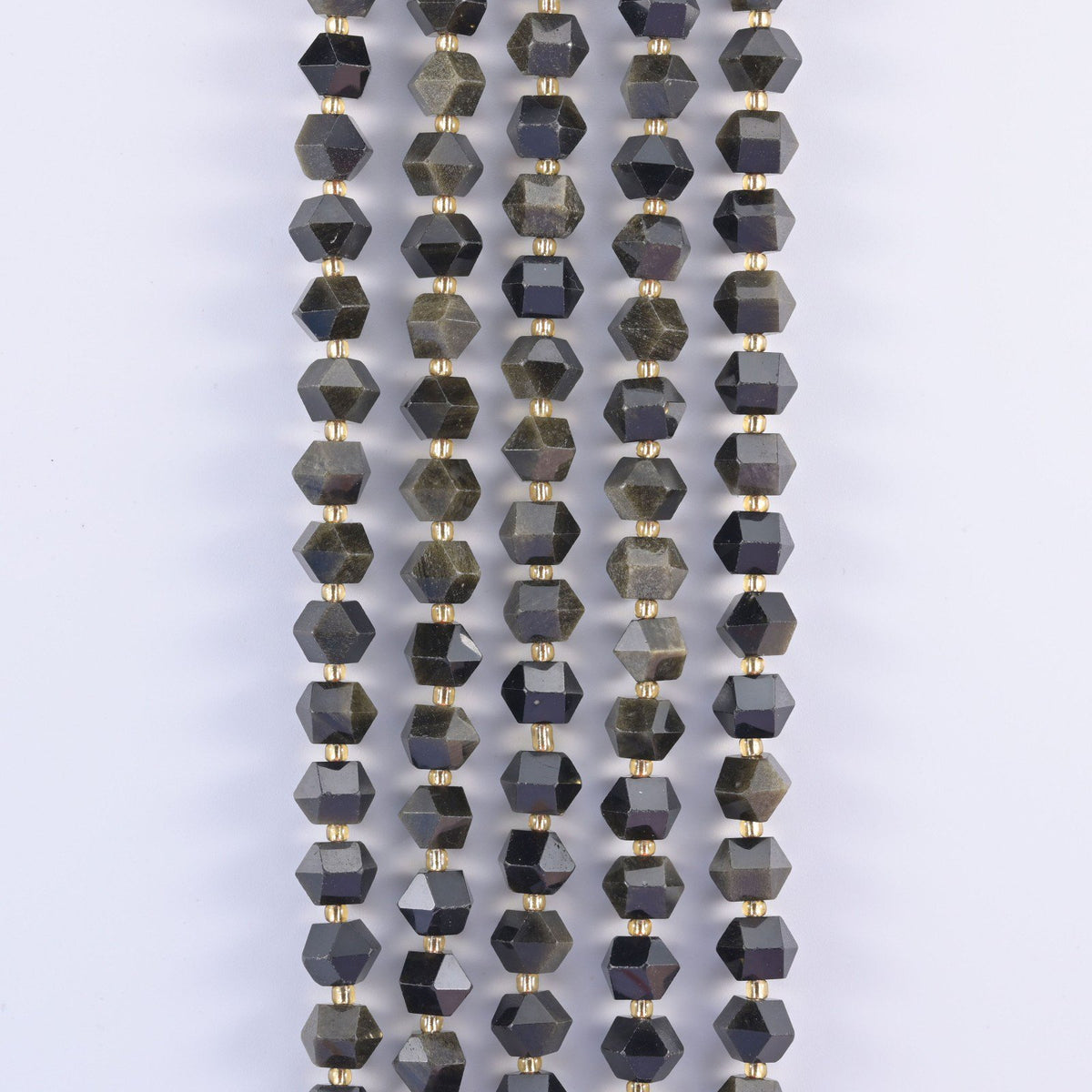 Faceted 8 sides diamond rhombus beads in gold obsidian in vertical rows, gold sheen shifting across the cut faces.