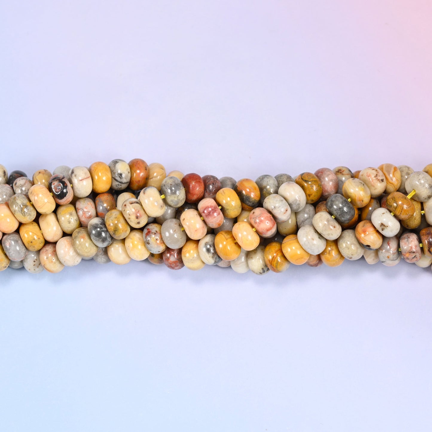 Close-up of coiled Crazy Agate beads showing the natural texture and mineral veining.