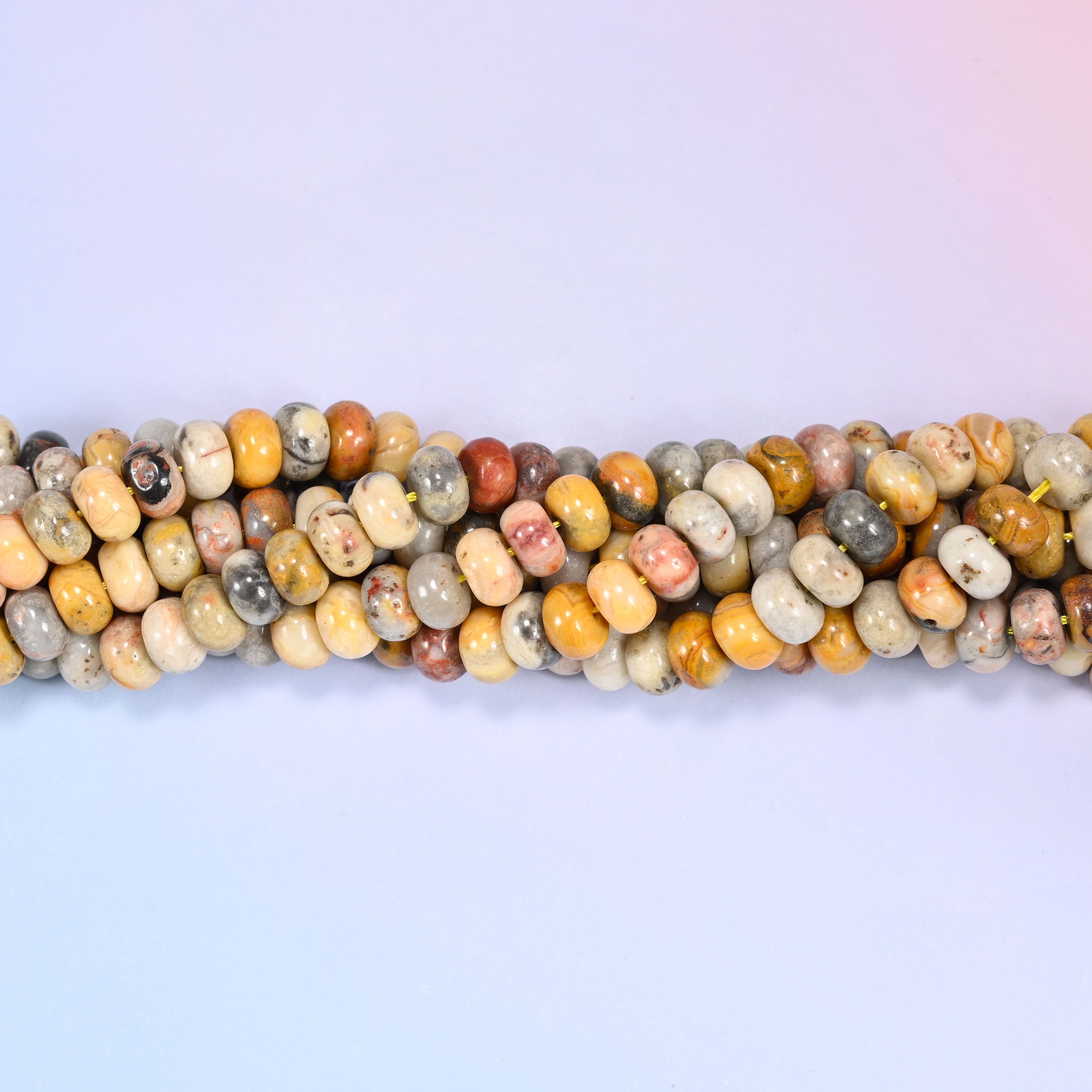 Close-up of coiled Crazy Agate beads showing the natural texture and mineral veining.