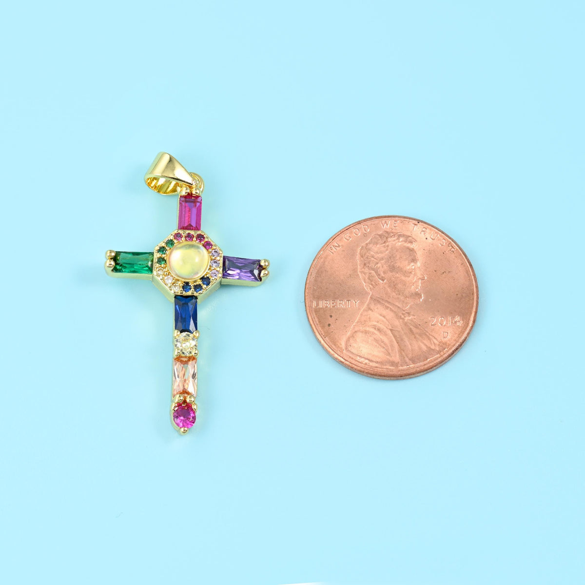 18K gold plated cross zirconia pendant beside a US penny, the cross taller than the coin.