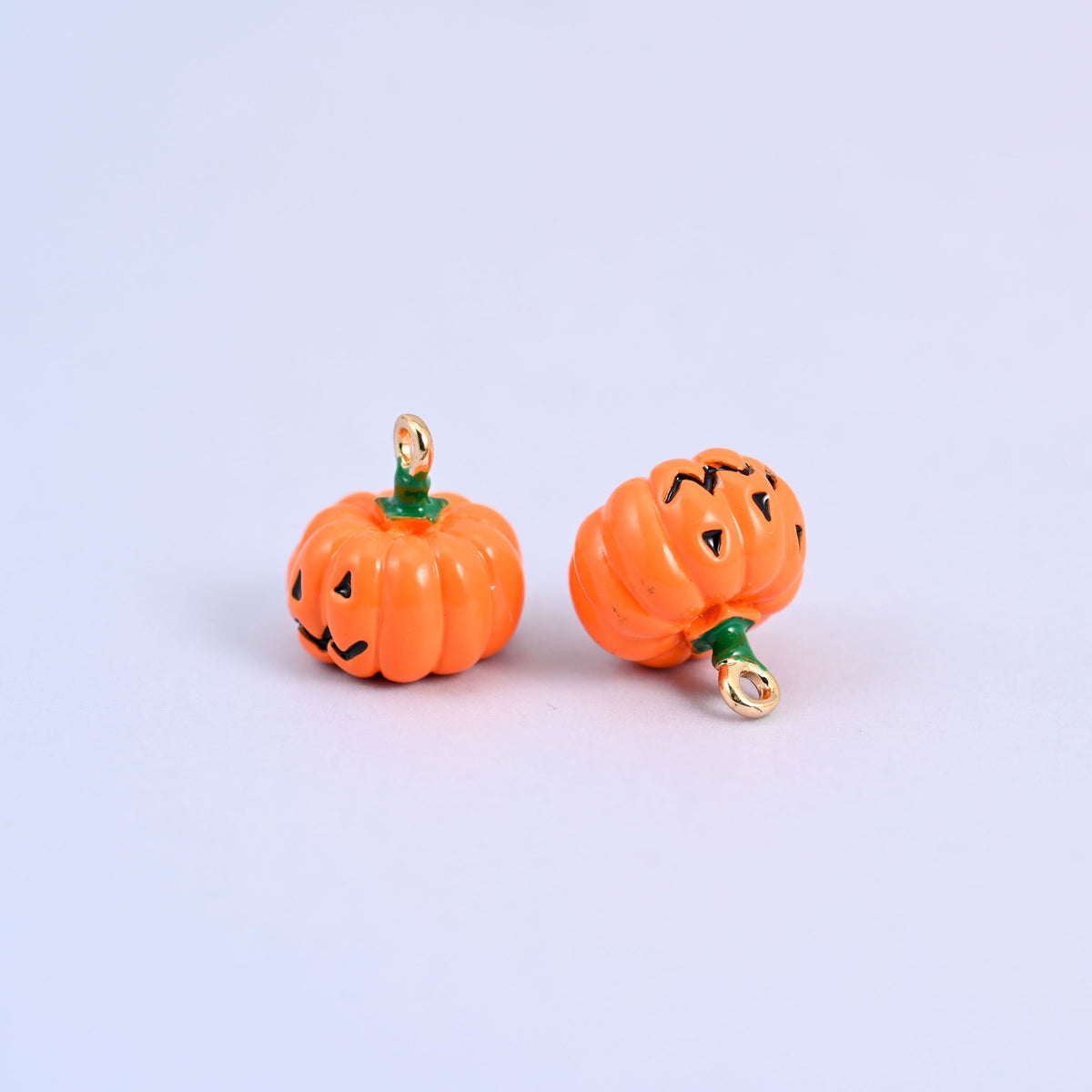 Two enamel pumpkin charms in orange enamel, measuring 12.57 x 13.21mm including the ring.
