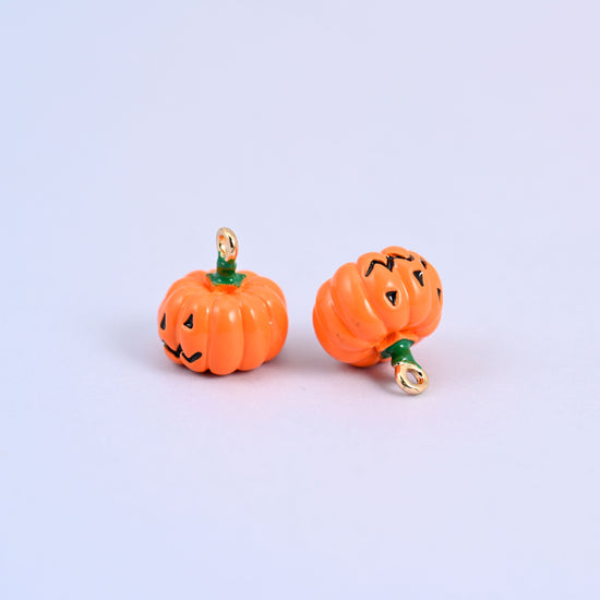 Two enamel pumpkin charms in orange enamel, measuring 12.57 x 13.21mm including the ring.