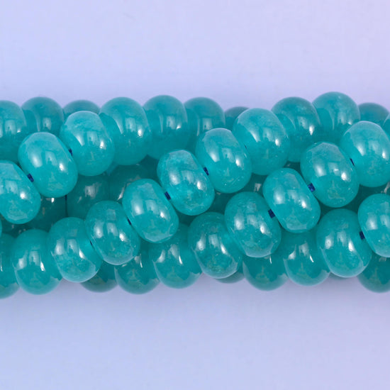 Smooth rondelle cut dyed jade beads with a polished surface
