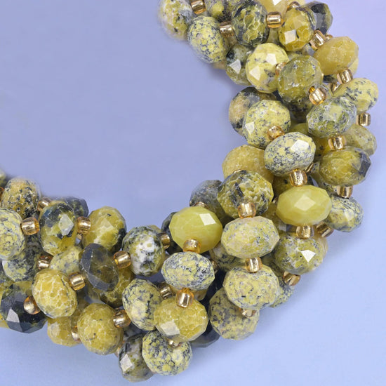 Faceted rondelle cut yellow howlite beads