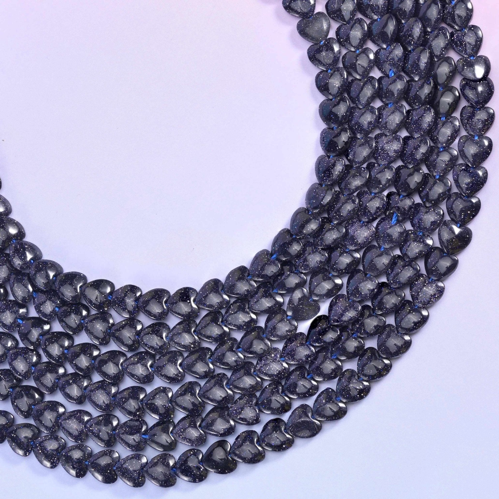 Blue Sandstone (man-made glass) hearts, midnight blue that reads almost black until copper sparkle catches the light