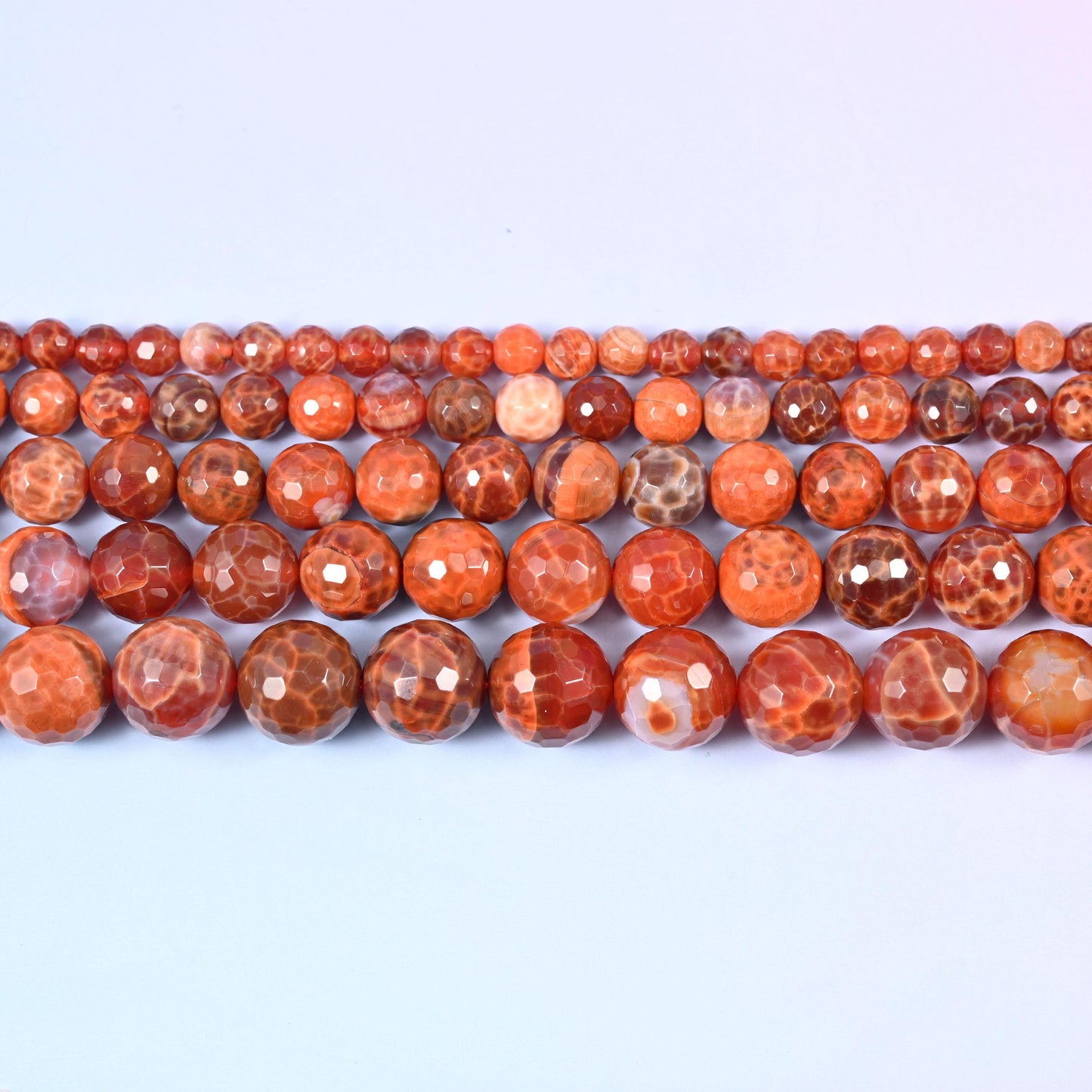 Fire Agate Faceted Round Beads in hot coral-orange with creamy white crackle patterning