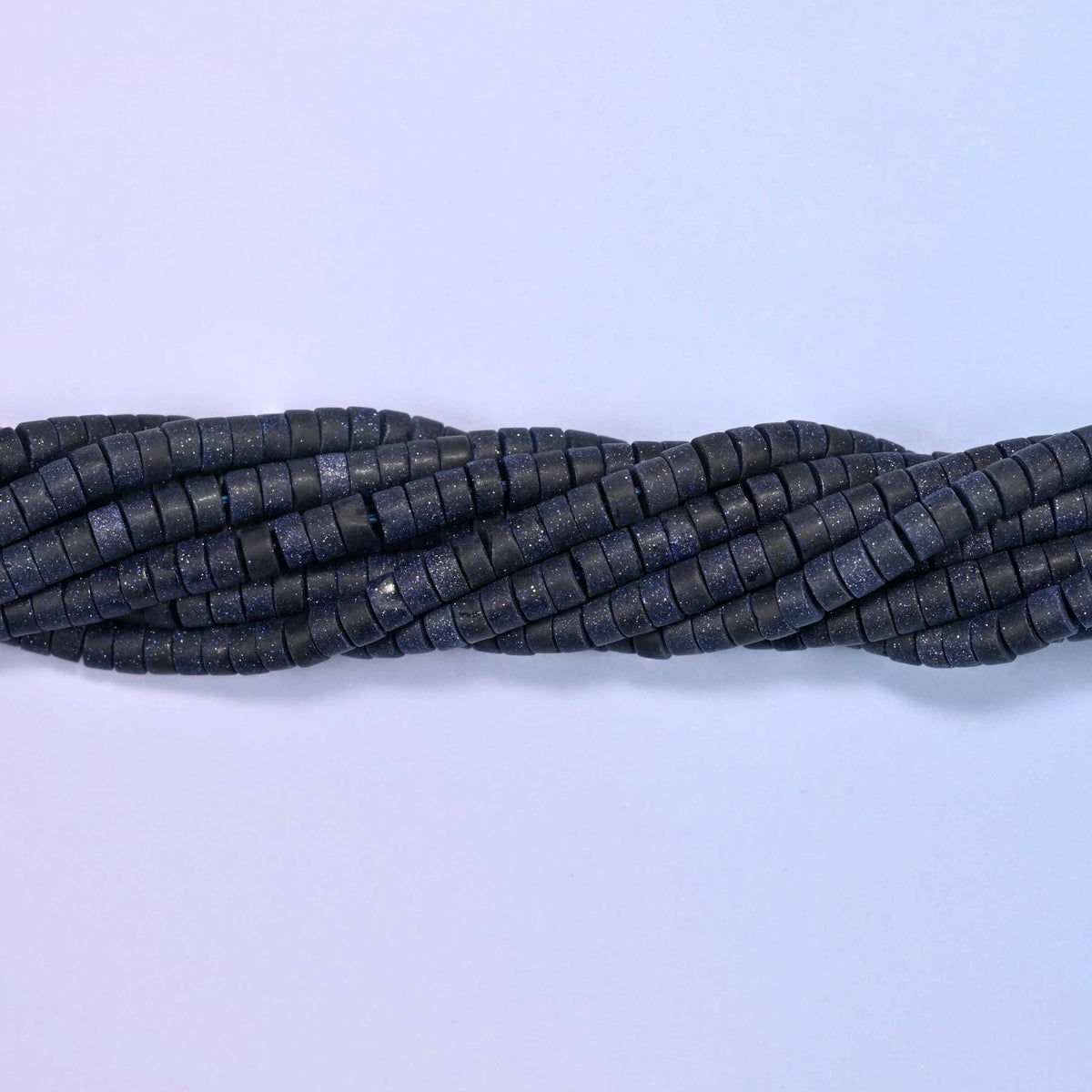 Matte blue sandstone heishi disc beads, approximately 155 per strand